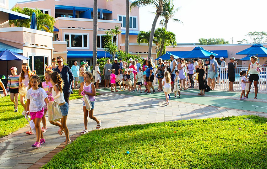 After making their way to various sections of the resort grounds divided by age group, children participating in the Sand Cay Easter egg hunt quickly got to work filling up their baskets with colorful eggs.