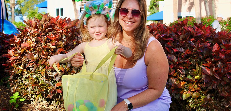 Lydia Lardner, 3, makes an impressive start filling up her Easter basket with Kelly Lardner and family at the April 3 Sand Cay Condominiums Beach Resort's Easter egg hunt, a beloved tradition at the resort for more than a decade.