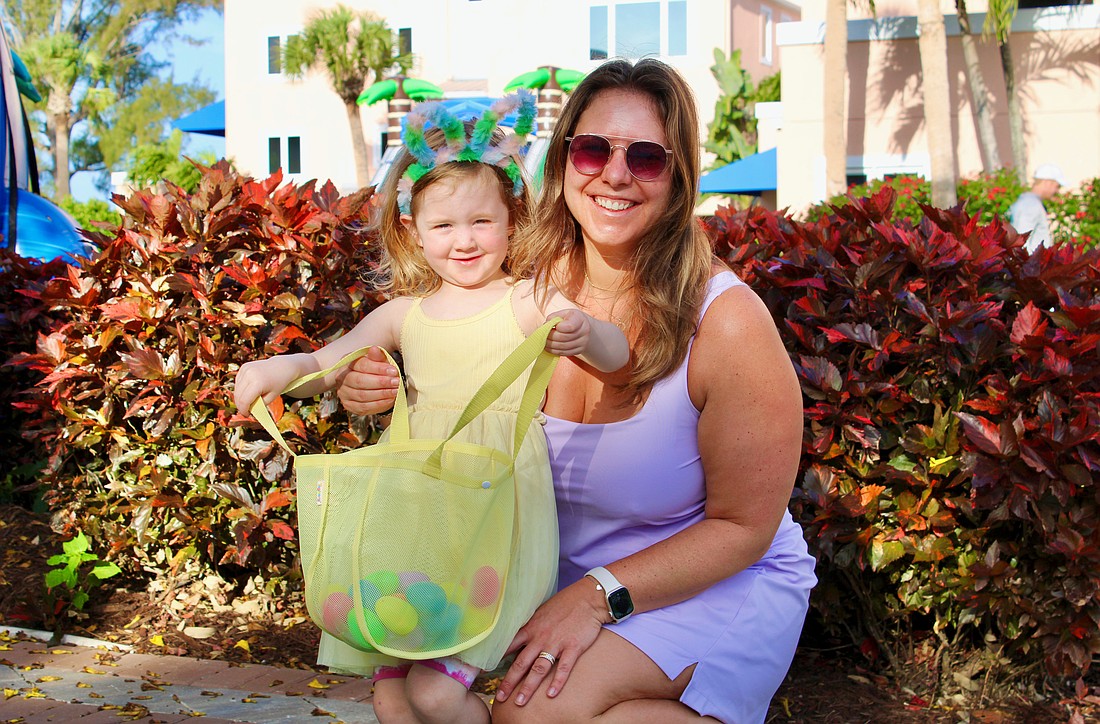 Lydia Lardner, 3, makes an impressive start filling up her Easter basket with Kelly Lardner and family at the April 3 Sand Cay Condominiums Beach Resort's Easter egg hunt, a beloved tradition at the resort for more than a decade.