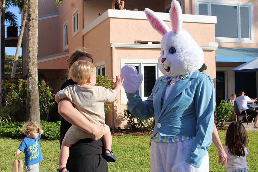 The Easter Bunny doles out high fives at the Sandy Cay holiday extravaganza.