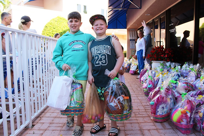 Julian Smith and Elliott Nurenberg pick out their Easter baskets they won from the egg hunt at the Sand Cay Condominiums Beach Resort.
