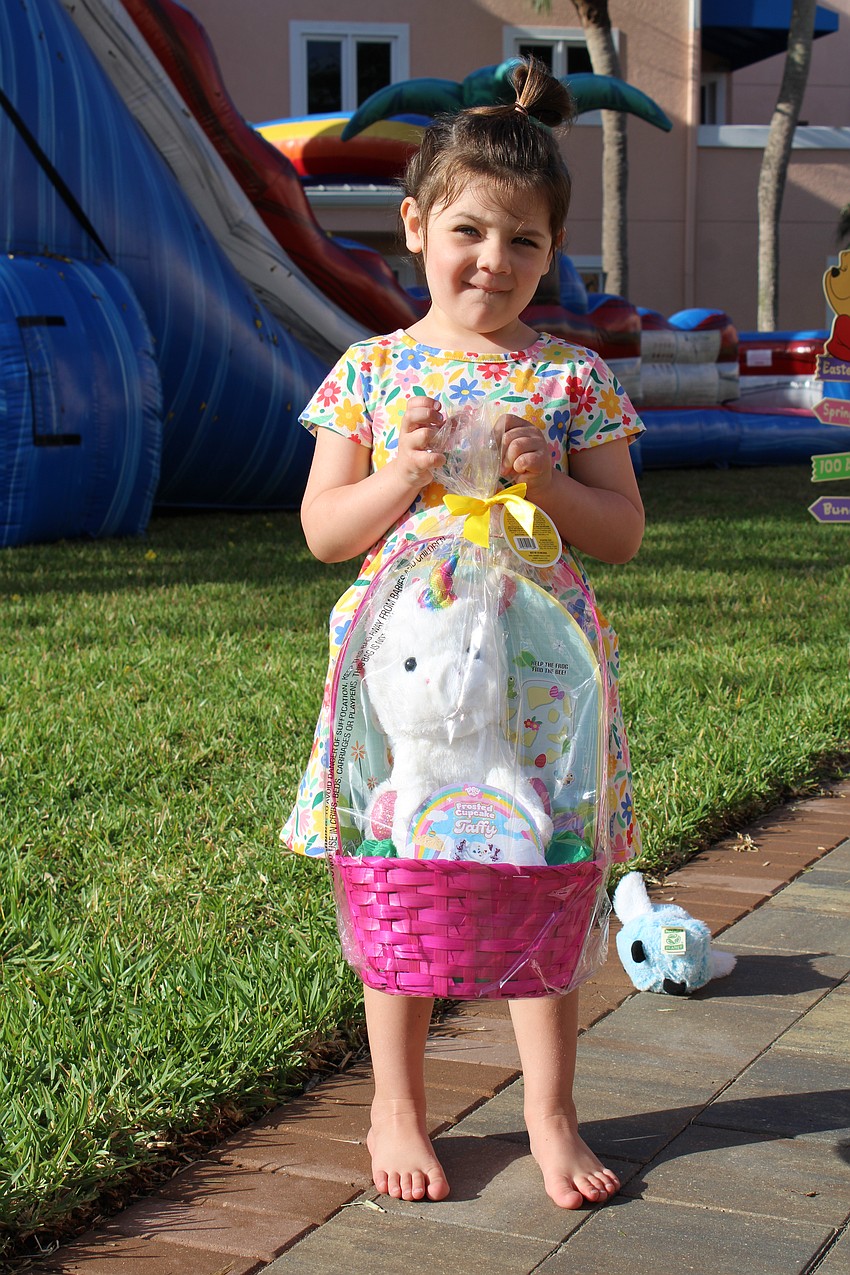 Maeve Mcauliff, 3.5, pickd an Easter basket with a unicorn at the Sand Cay egg hunt.