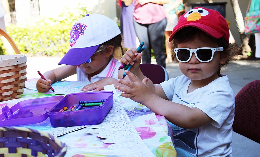Leo, 2, and Blair, 3, Sobotka color in their Easter-themed paper crowns at the craft table before joining the newly returned St. Armands Key Lutheran Church Easter egg hunt on April 4.