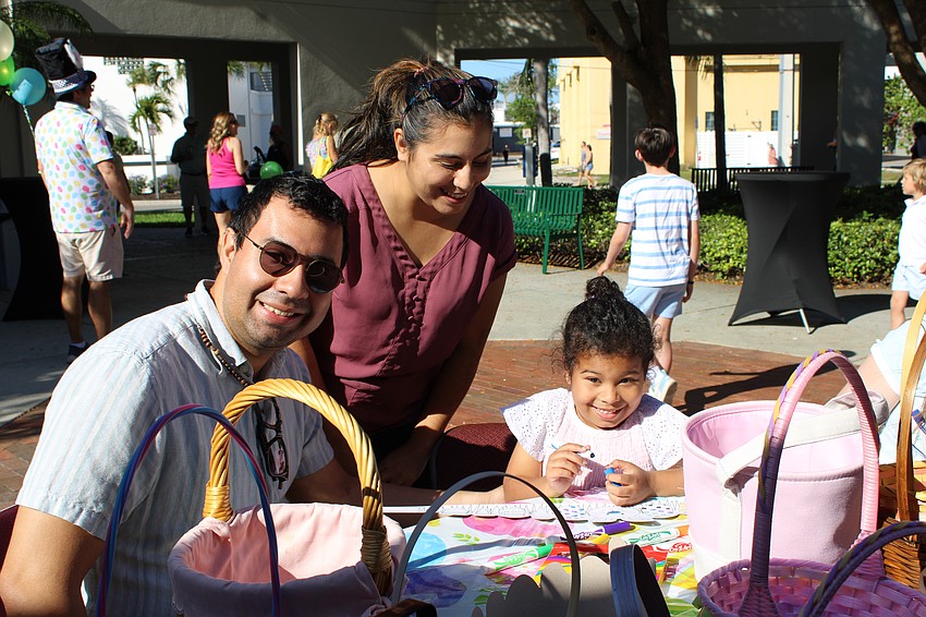 Andres, Mey and 5-year-old Andrea Paz check out the crafts before the St. Armands Key Lutheran Church Easter egg hunt on April 4.