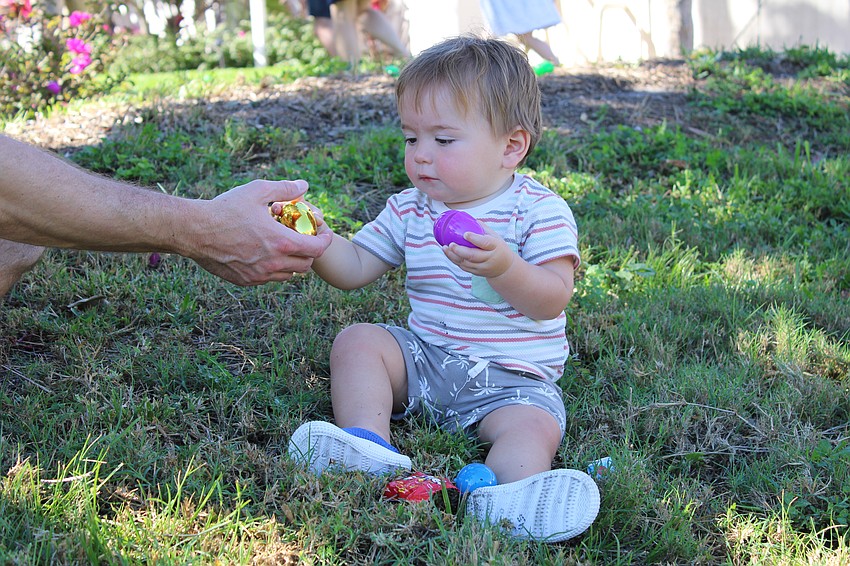Sam Deheer, 13 months old, investigates some Easter eggs.