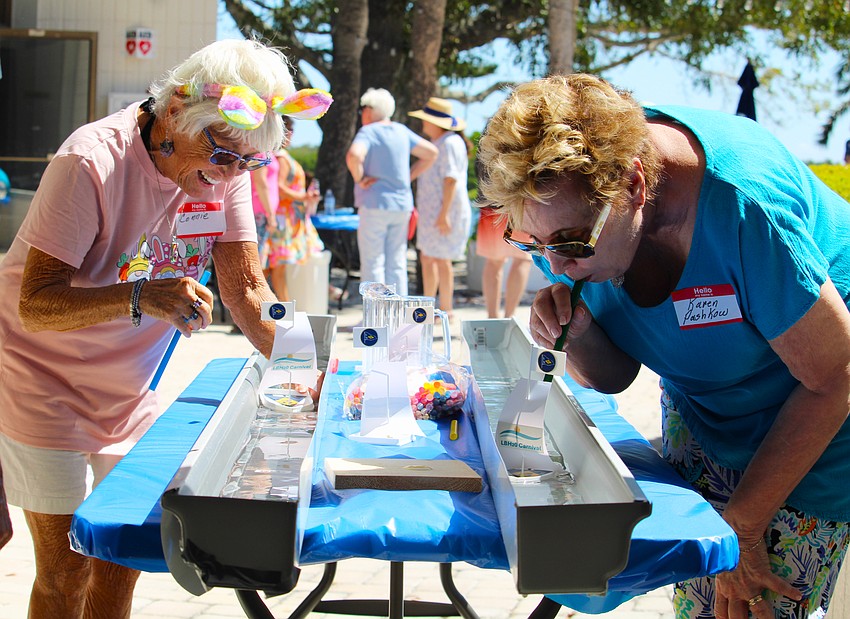 Connie DiMaggio contends with an unfortunate capsizing of her straw-propelled sailboat when competing with Karen Pashkow at Longboat Harbour Condominiums' holiday festivities on April 4, which featured the organization's first Easter egg hunt. Pashkow said the weather, attendance and all the other factors came together perfectly for the inaugural event.