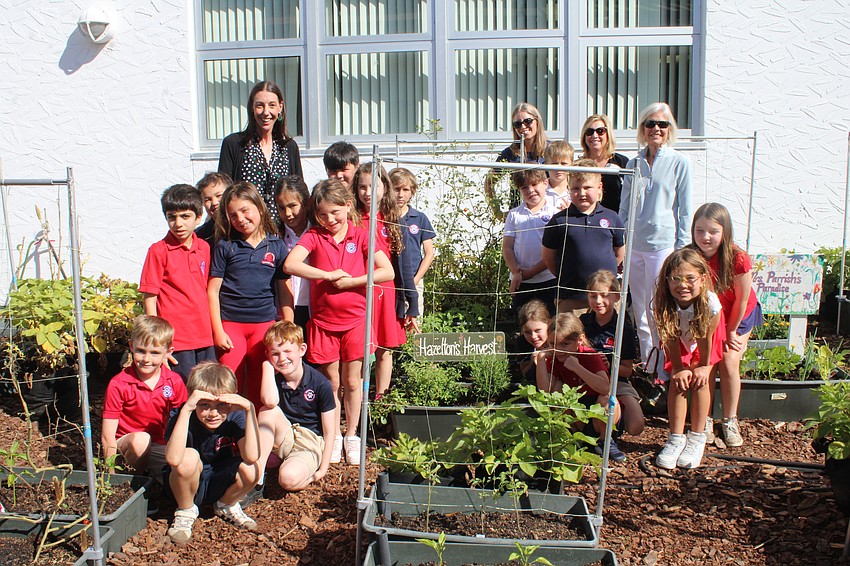 Teacher Kirsten Hazelton's 2nd-grade class at Southside Elementary School shows touring members of the Longboat Key Garden Club how their patch in the school vegetable garden is progressing. The garden club is focusing its fundraising efforts on supporting these school gardens with the upcoming Giving Challenge on April 15.
