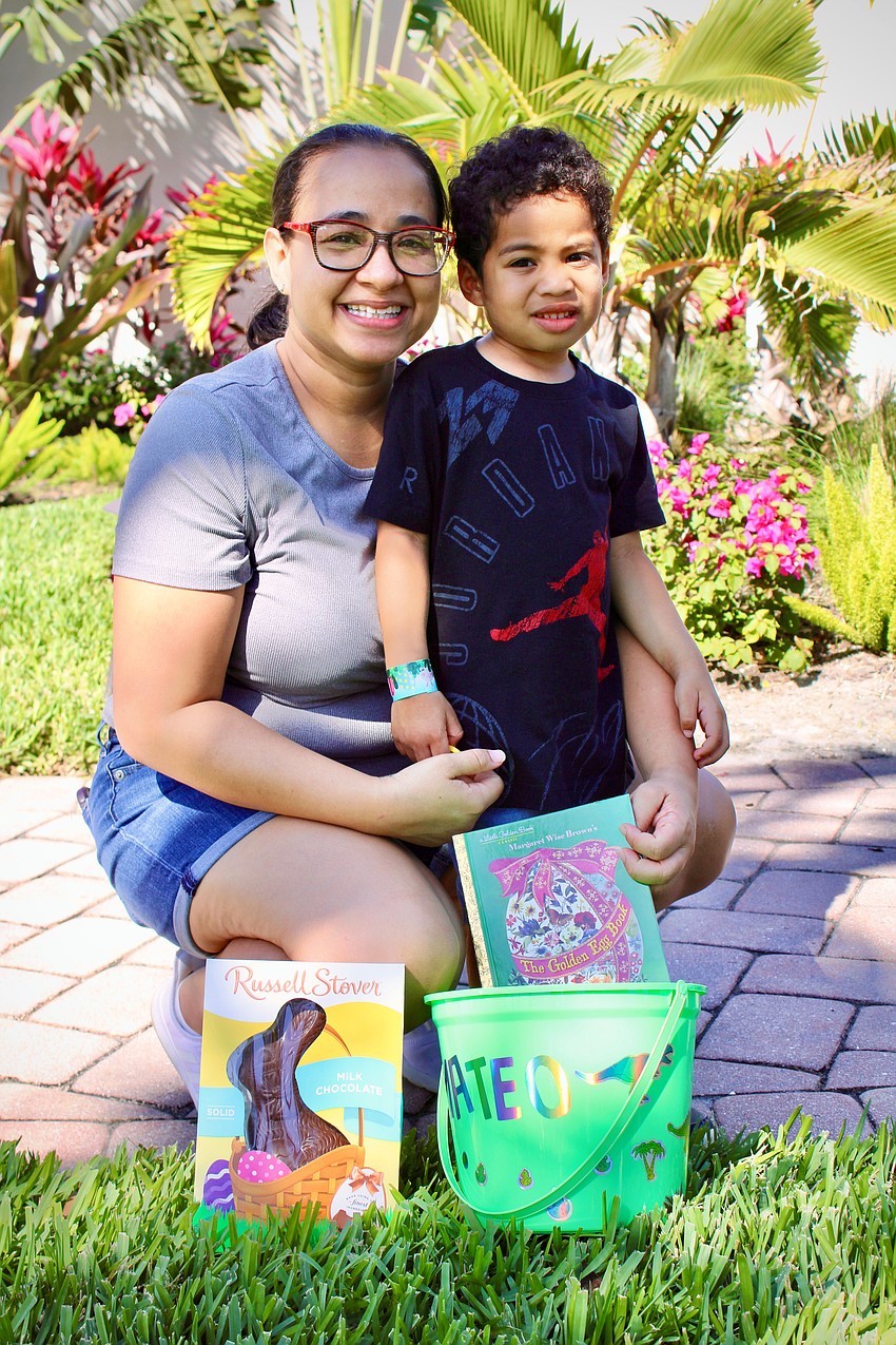 Four-year-old Mateo Reyes, pictured with Catalina Reyes, is among the talented Easter egg hunters to find a golden egg and take home a chocolate bunny and picture books, along with his other Easter eggs.