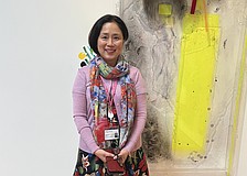 Sarasota Art Museum Senior Curator Rangsook Yoon poses in front of an unnamed piece in Judy Pfaff's exhibition, "Picking Up the Pieces."
