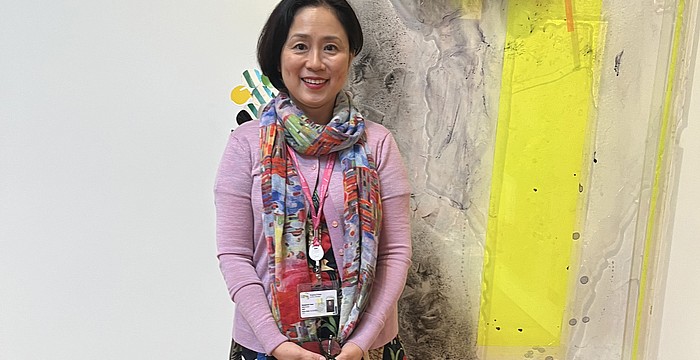 Sarasota Art Museum Senior Curator Rangsook Yoon poses in front of an unnamed piece in Judy Pfaff's exhibition, "Picking Up the Pieces."