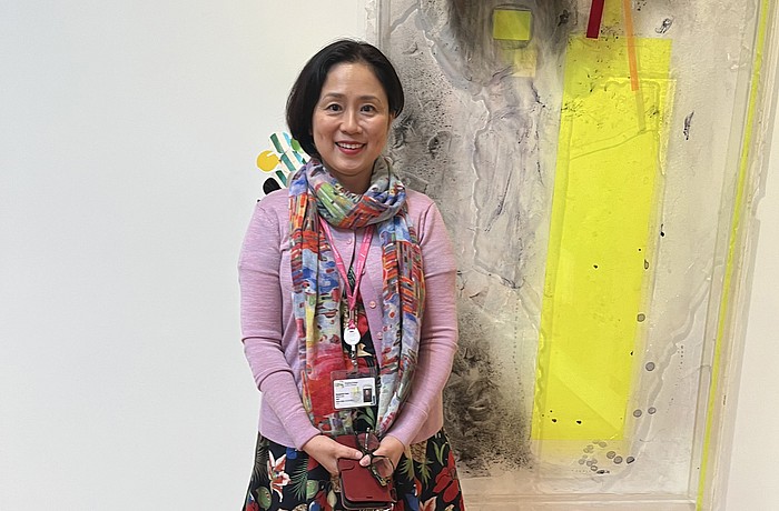 Sarasota Art Museum Senior Curator Rangsook Yoon poses in front of an unnamed piece in Judy Pfaff's exhibition, "Picking Up the Pieces."