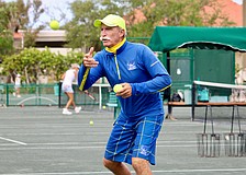 Longboat Key Tennis Center pro Robbie Salum tosses a tennis ball up for warm-ups at a clinic on April 8. He and his fellow pros shared what they find special about the public courts and insight into the career paths that led them there.