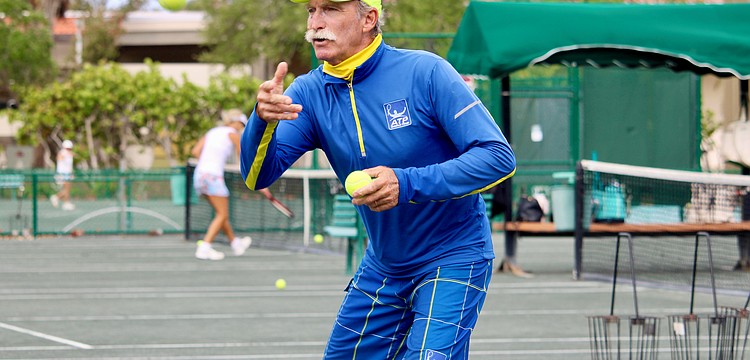 Longboat Key Tennis Center pro Robbie Salum tosses a tennis ball up for warm-ups at a clinic on April 8. He and his fellow pros shared what they find special about the public courts and insight into the career paths that led them there.