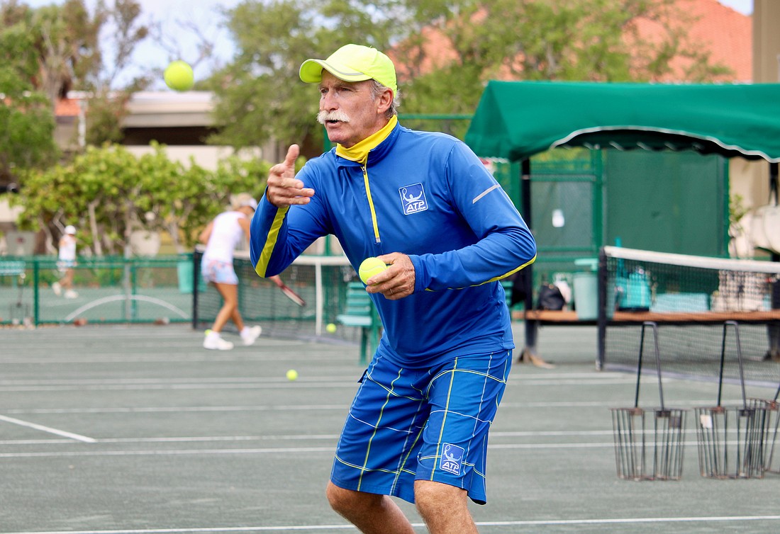Longboat Key Tennis Center pro Robbie Salum tosses a tennis ball up for warm-ups at a clinic on April 8. He and his fellow pros shared what they find special about the public courts and insight into the career paths that led them there.