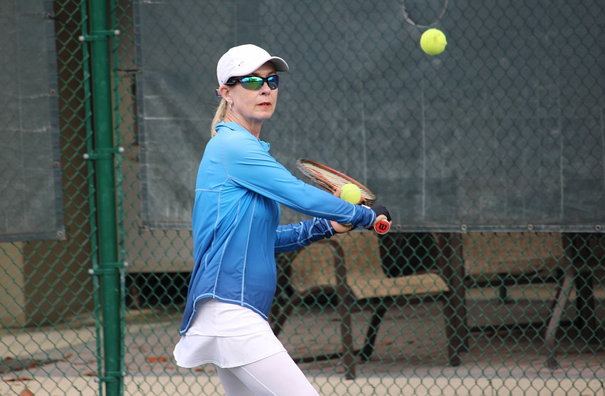 Longboat Key Tennis Center manager Kay Thayer eyes the ball while giving a one-on-one lesson.