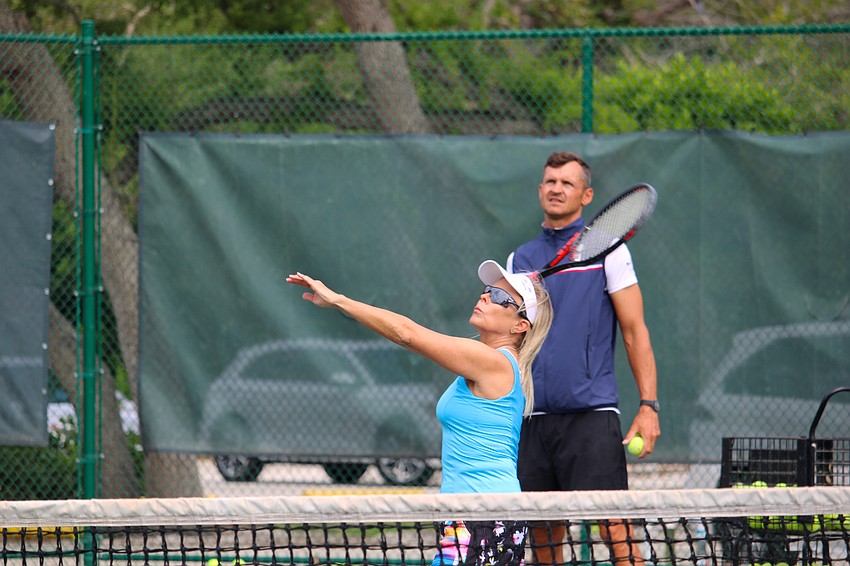 Jennifer Maita and instructor Tomasz Borucki both closely watch the serve in the air at the April 8 clinic.