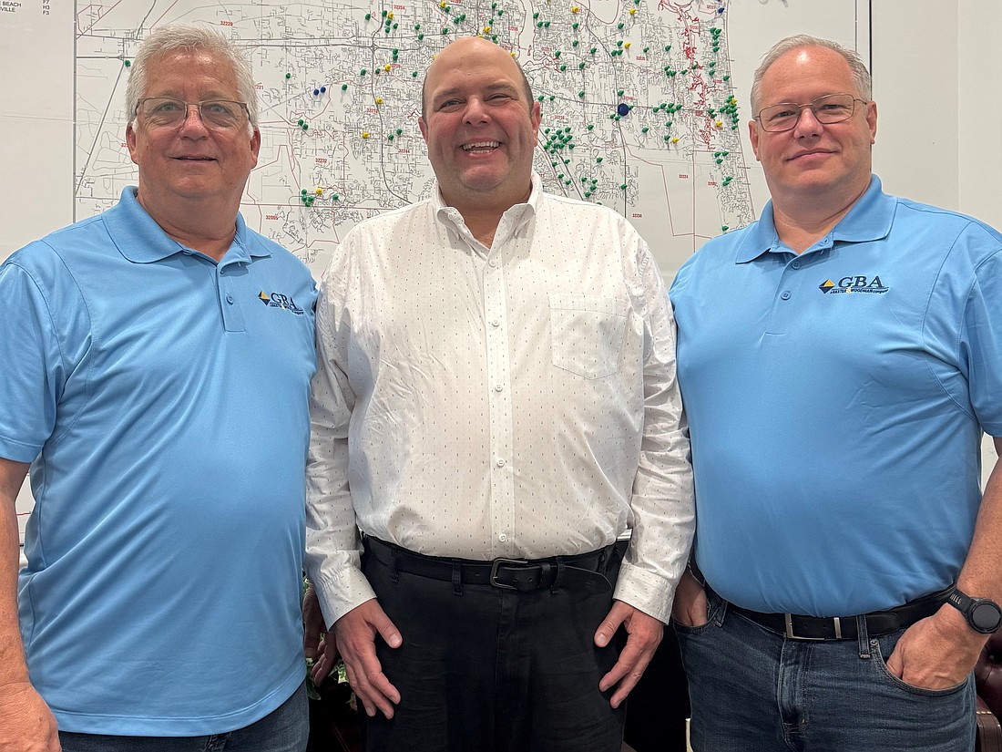 Goodson Bergen founders Edward Goodson, left, and Jeffrey Bergen, right, with Baxter & Woodman CEO Louis Haussmann. The Jacksonville company now is GBA, a Baxter & Woodman company, after a March 13 merger.