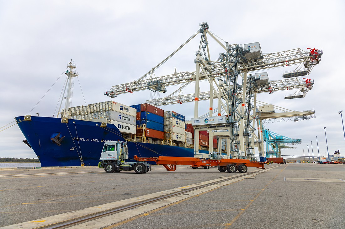 Cranes work near cargo ships at Blount Island Marine Terminal.
