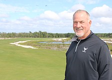 Steve Herrig, the owner of the Miakka Golf Club, which is expected to open in November, stands in front of a fairway and one of the many wetland areas formed by his course's construction.