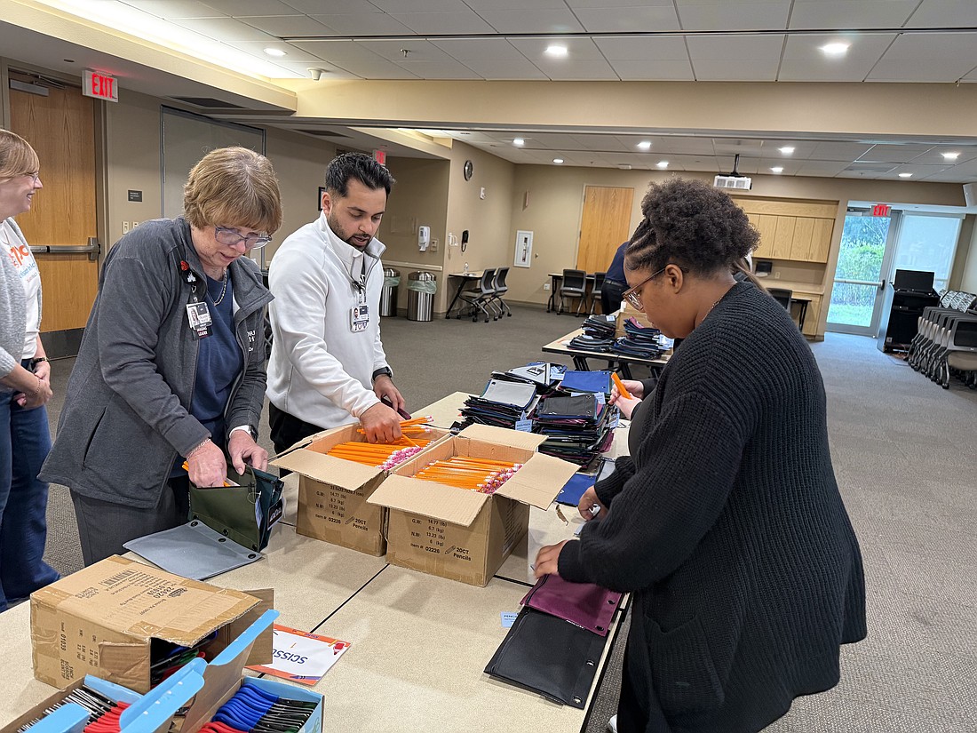 Volunteers at Orlando Health Dr. P. Phillips Hospital packed school supply kits for A Gift for Teaching as part of 407 Day.