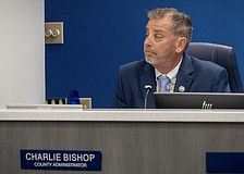 County Administrator Charlie Bishop is typically seated at the dais with commissioners during meetings, but he was absent during the discussion about his contract April 7.