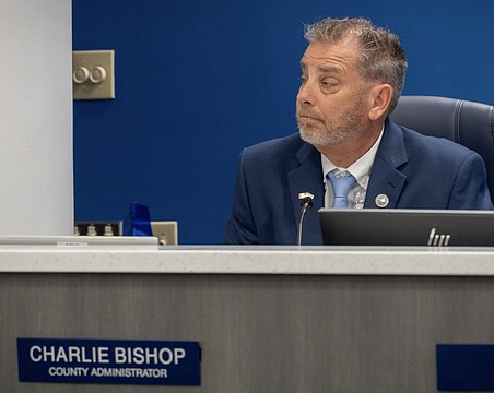County Administrator Charlie Bishop is typically seated at the dais with commissioners during meetings, but he was absent during the discussion about his contract April 7.