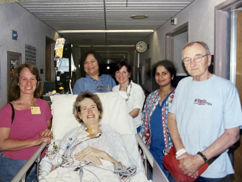 Sue Ann Miller is on her way to surgery and surrounded by her sister Cathy Jonas, three nurses and Don Davis, a fellow patient who was also waiting on a heart.