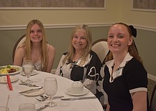 Chloe Jarvis, Vice President Donna Quilici-Smith and Sara Sweetnich socialize before the scholarships are given out at Palm Aire Country Club April 10.