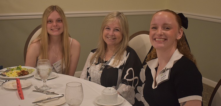 Chloe Jarvis, Vice President Donna Quilici-Smith and Sara Sweetnich socialize before the scholarships are given out at Palm Aire Country Club April 10.