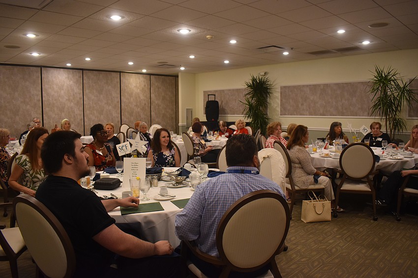 The Palm Aire Women's Club gather to present scholarships to students from State College of Florida and Manatee Technical College April 10.