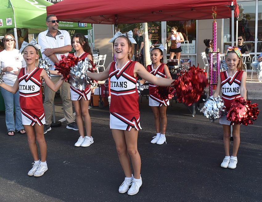 Lakewood Ranch Titans Kylie McCarthy, Zoey Solis, Jozlyn Olney, Juliet Bautista and Kiera McCarthy perform a cheer at the Lakewood Ranch Block Party April 10.