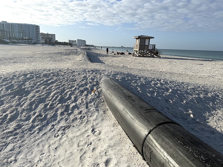 A temporary pipeline carries sand through Lido Beach after it is dredged from New Pass at the north end of Lido Key.