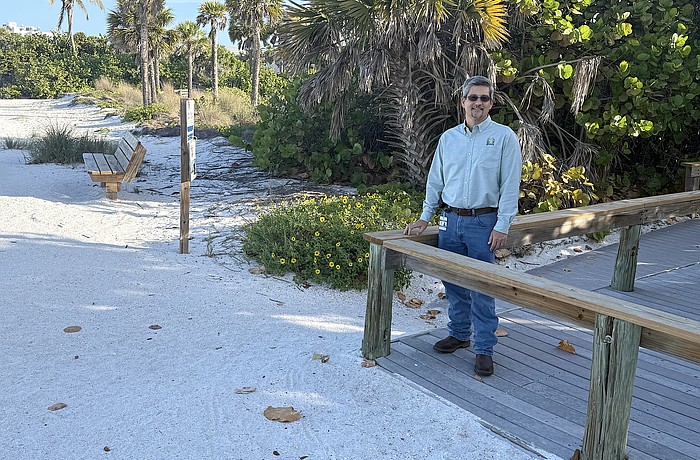 Sarasota City Engineer Sage Kamiya at the Lido Beach Pavilion walkover, which will be replaced when 6-foot-high dunes are built in the area.