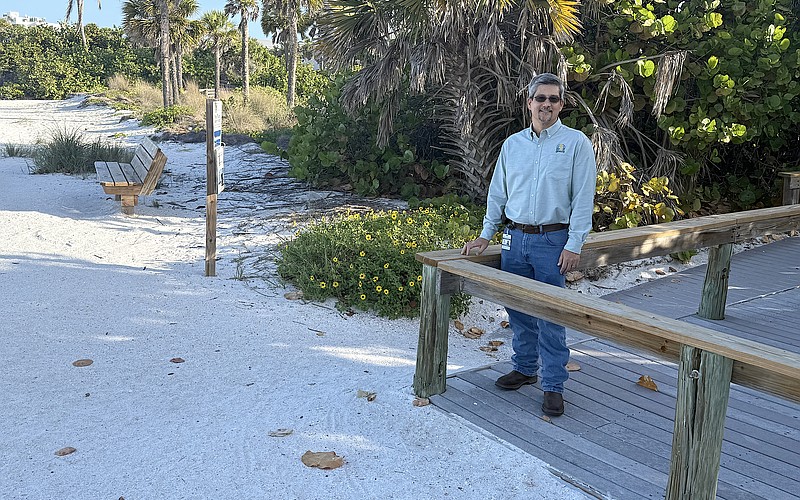 Sarasota City Engineer Sage Kamiya at the Lido Beach Pavilion walkover, which will be replaced when 6-foot-high dunes are built in the area.