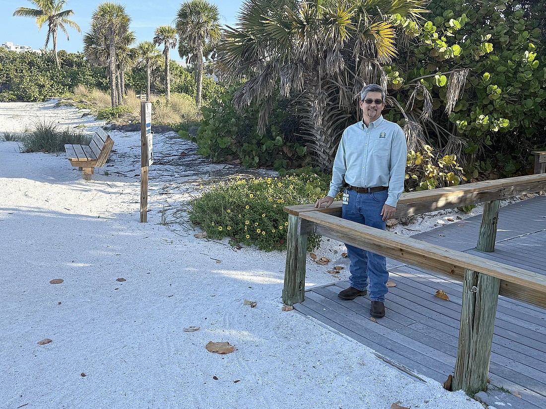 Sarasota City Engineer Sage Kamiya at the Lido Beach Pavilion walkover, which will be replaced when 6-foot-high dunes are built in the area.