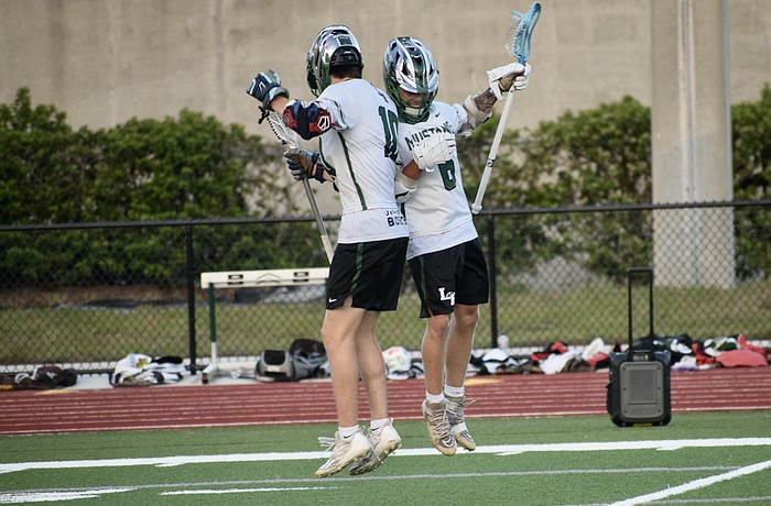 Junior Jackson Zackery (left) celebrates with senior Peyton Hens (right) after a goal against Sarasota High on April 9 in the FHSAA Class 2A-District 12 quarterfinals. Lakewood Ranch advanced with a 13-4 victory.