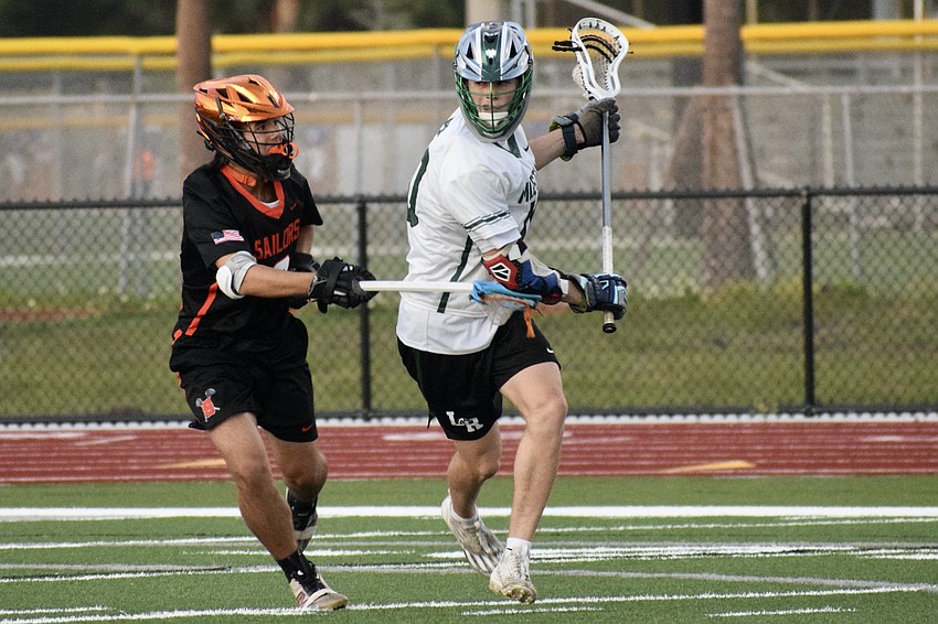 Jackson Zackery (right) evades Liam Cooper (left) near the Sailors' net. He's the only non-senior to rank top-five in scoring for the Mustangs this season.