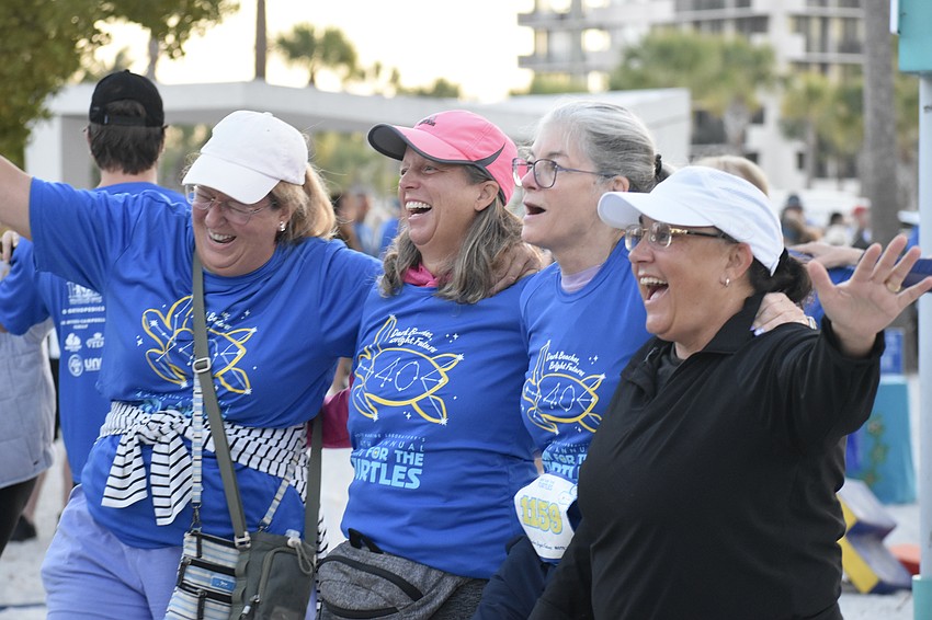 Nancy Vickroy, Pam Pruett, Joyce Maples and Ginny Collins join one another in the stretching activity.