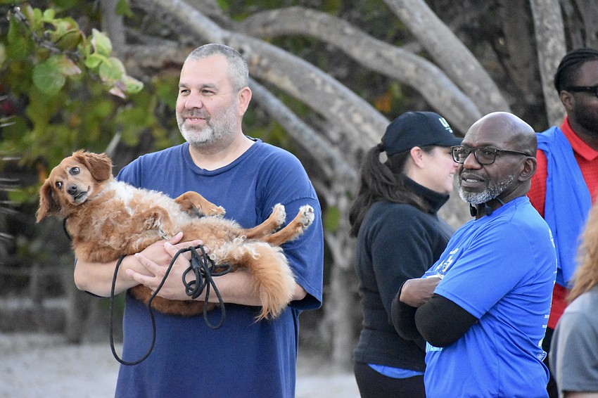 Robert Khannomee, his dog Samson, and Dariel Underwood watch as the event gets underway.