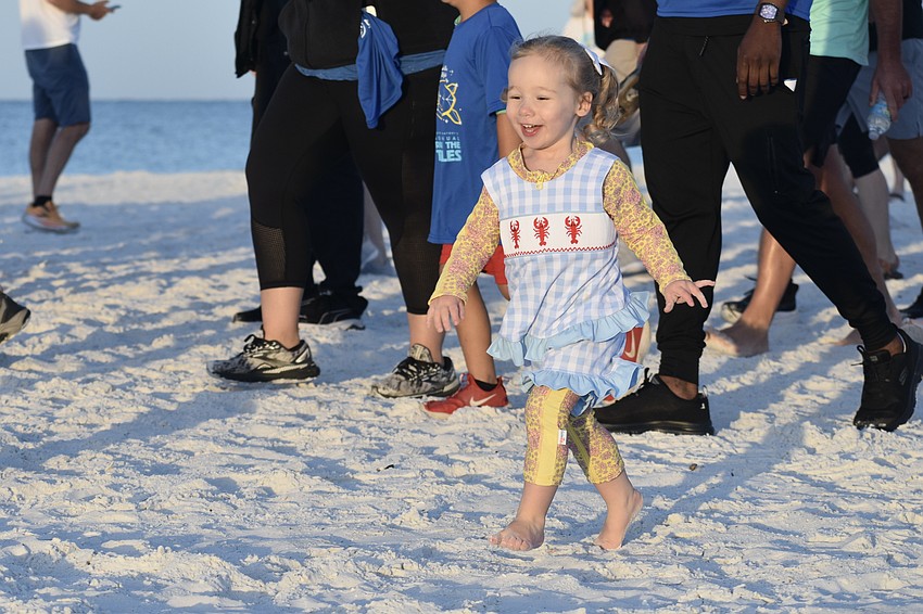 Georgia Armstrong, 2, sets off on the fun run.