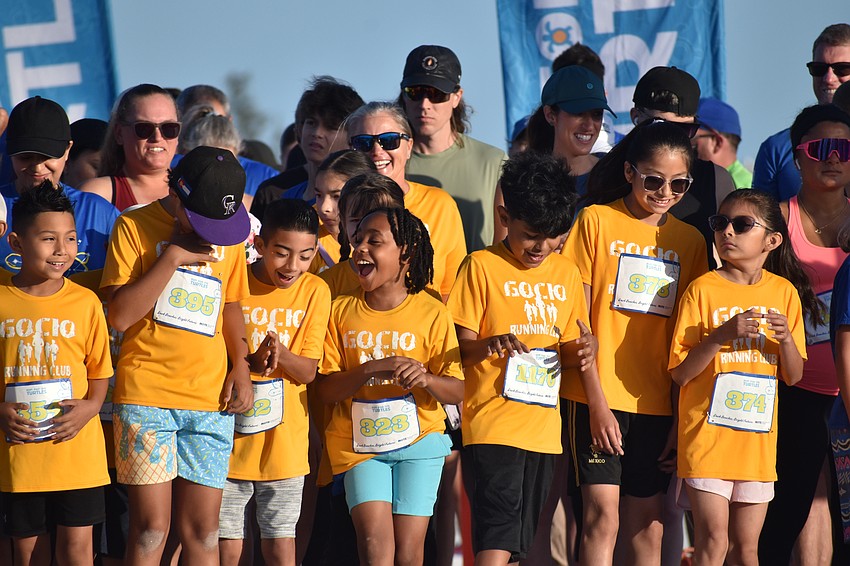 Runners, including students from Gocio Elementary School Runners Club, prepare to start the 5K.