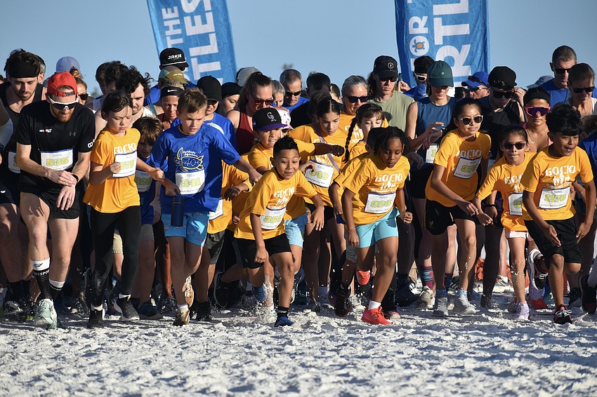 Runners, including students from Gocio Elementary School Runners Club, begin the 5K.