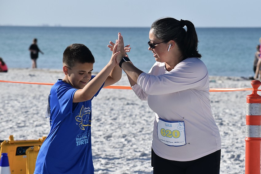 Gage Souza, 10, and his mom Hilary Souza, celebrate a job well done.