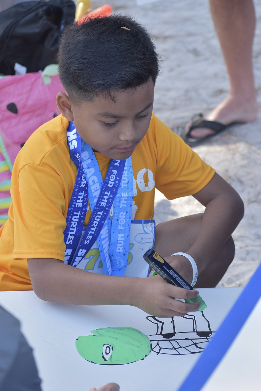 Bruno Hernandez, 9, draws a turtle.