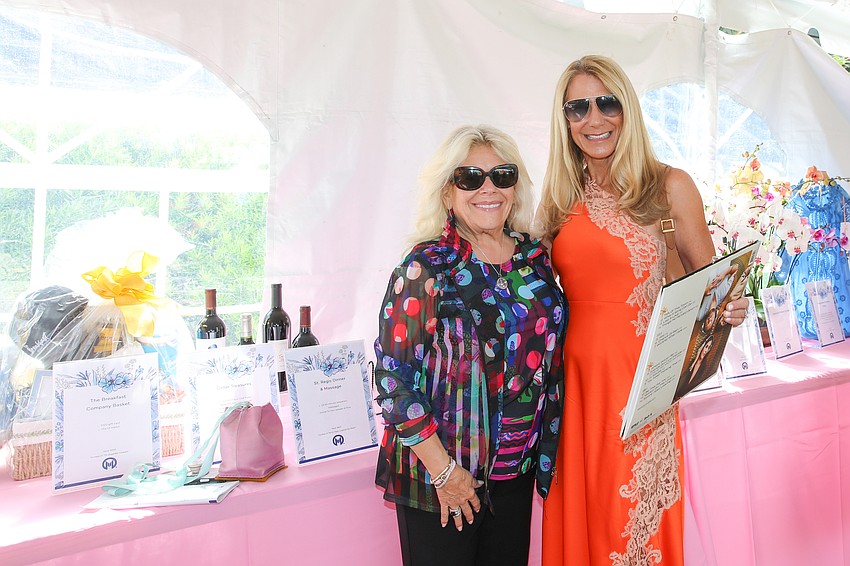 Lori Greenbaum and Janet Walter peruse the silent auction tables.
