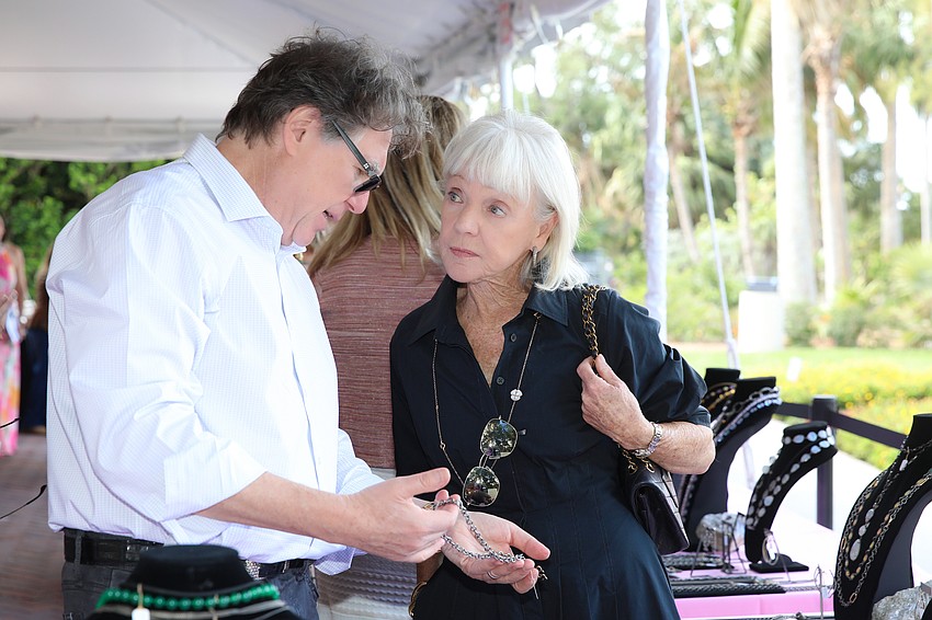 Greg Gilin shows jewelry to Diana Smith.