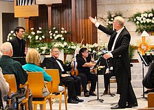 Conductor Glen Olsen introduces trumpet soloist Ricardo Chinchilla, who accompanied members of the Sarasota Bay Chamber Orchestra on April 10 for an end-of-season performance at St. Armands Key Lutheran Church.