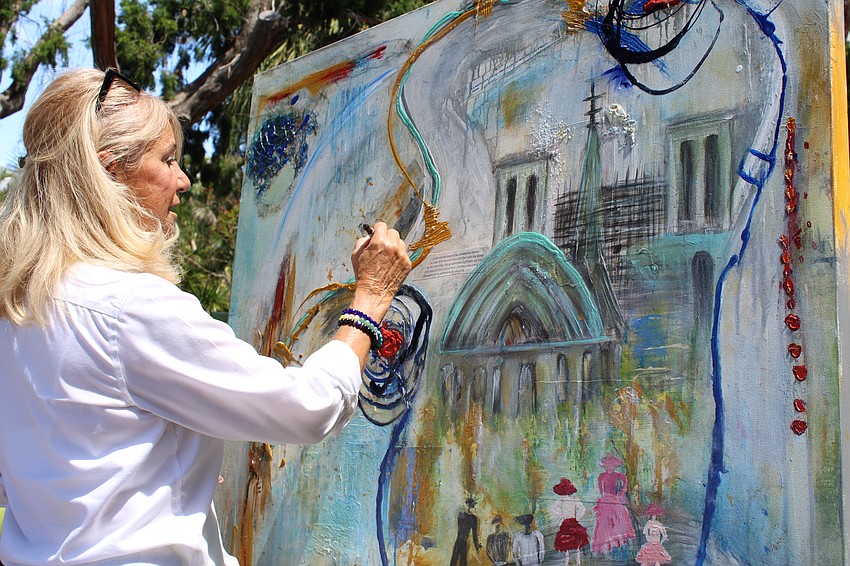 Artist Marie Therese Lacroix, returning for the second year of Artists in the Garden, explains her layering techniques used in a piece featuring Notre-Dame de Paris.