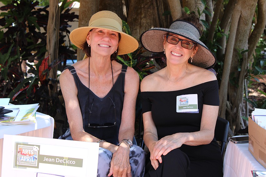 Lynn Armstrong Coffin and Jean DeCicco share a shady respite while showcasing their work at Artists in the Garden.
