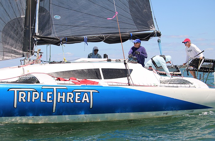 The team aboard the "Triple Threat," captained by John Novak, rounds the first marker of the Bird Key Yacht Club's annual Sarasota Bay Cup regatta on April 11.
